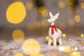 Decorative Christmas-themed figurines. Christmas deer. Christmas tree decoration. Festive decor, warm bokeh lights