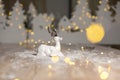 Decorative Christmas-themed figurines. Christmas deer. Christmas tree decoration. Festive decor, warm bokeh lights