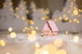 Decorative Christmas-themed figurines. Little toy house, Christmas tale. Christmas tree decoration. Festive decor, warm bokeh Royalty Free Stock Photo
