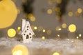 Decorative Christmas-themed figurines. Little toy house, Christmas tale. Christmas tree decoration. Festive decor, warm bokeh Royalty Free Stock Photo