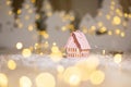 Decorative Christmas-themed figurines. Little toy house, Christmas tale. Christmas tree decoration. Festive decor, warm bokeh Royalty Free Stock Photo