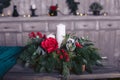Decorative Christmas tree branches with candle and roses in the basket