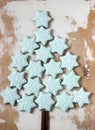 Christmas tree made from blue gingerbread cookies and cinnamon sticks on a light wooden background. Rustic style. Royalty Free Stock Photo