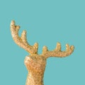 Decorative Christmas tree reindeer ornament close up on a pastel blue background. Royalty Free Stock Photo