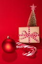 decorative Christmas trees and gift boxes on red background against red background Royalty Free Stock Photo