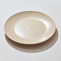 Porcelain handmade empty plate in a pastel color on a gray background with shadows. Royalty Free Stock Photo