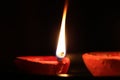 Decorative Clay diya or Oil Lamp lit during festival. Selective focus