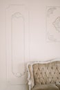 Decorative clay stucco relief molding with ornaments on white ceiling in classical style interior with part of vintage