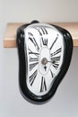 Decorative clocks drain off the shelf. The clock is a symbol of the impermanence of time. Royalty Free Stock Photo