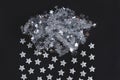 Decorative cloud of tinsel of silver color on a black background. Holiday concept. flat lay, top view Royalty Free Stock Photo