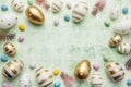 Decorative colored Easter eggs on a green wooden background