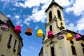 Decorative colorful canvas lamp shades supended on steel wire above public street Royalty Free Stock Photo