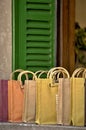 Decorative colored cloth bags in front of a window Royalty Free Stock Photo