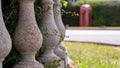 Decorative columns of property boundary in small village with red phonebox in background