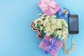 Decorative composition boxes with gifts flowers women& x27;s jewelry shopping holiday blue background.