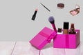 Decorative composition of colorful beauty and makeup products and tools in a pink gift box on a bright table and with further Royalty Free Stock Photo