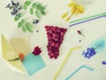 Decorative composition - a glass of fresh raspberries, cocktail tubules, fresh flowers, petals and berries on a light background