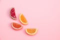 Yellow, red, orange Jelly sweet candies in shape of fruits wedges on pink background
