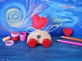 Decorative composition of a toy car and a heart made of felt, paints and pencils on the background of pastel drawing, the concept Royalty Free Stock Photo