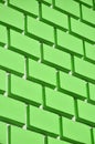 Decorative concrete wall with a relief similar to a large brick masonry painted in bright green pain Royalty Free Stock Photo