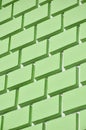 Decorative concrete wall with a relief similar to a large brick masonry painted in bright green paint Royalty Free Stock Photo