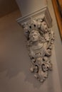 Decorative corbel in a house with bust of a woman, painted cast plaster