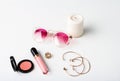 Decorative cosmetics accessories candle and sunglasses over white background.