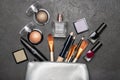Decorative cosmetics and cosmetic bag on a black background. Royalty Free Stock Photo