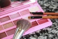 Decorative cosmetics, eye shadow palette and a makeup brushes Royalty Free Stock Photo