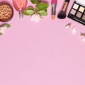 Decorative cosmetics mascara powder lipstick eyeshadow blush balls makeup brush perfume blooming spring branches on pink Royalty Free Stock Photo