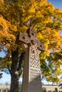 Cemetery Grave Stone Cross And Autumn Folliage