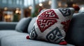 Decorative Cushion with Intricate Red and Black Patterns on Sofa Royalty Free Stock Photo