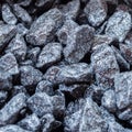 Decorative dark pebbles, like coal, close-up, background, texture. For modern abstract pattern, wallpaper or banner Royalty Free Stock Photo