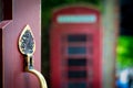 Decorative door handle with English phone booth in the background Royalty Free Stock Photo