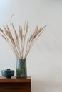 Decorative dried grass in green vase