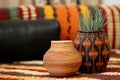 decorative earthenware pot on an african handwoven mat with kinara Royalty Free Stock Photo