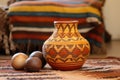 decorative earthenware pot on an african handwoven mat with kinara Royalty Free Stock Photo