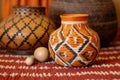 decorative earthenware pot on an african handwoven mat with kinara Royalty Free Stock Photo