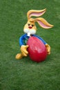 Decorative Easter bunny holding a big red egg Royalty Free Stock Photo