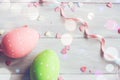 Decorative easter eggs on white wooden background