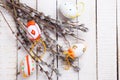 Decorative Eeaster eggs and willow branches on wooden background