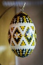 A decorative egg with a black and yellow design on it Royalty Free Stock Photo