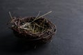 Decorative empty willow birds nest on dark rusty background. Copyspace