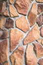 Decorative facade facing or original paved pathway, made as asymmetric mosaic of natural stone of different sizes and shapes. Royalty Free Stock Photo