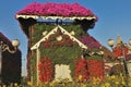 Decorative fairy house in the park against the blue sky.