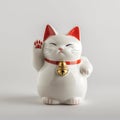 Decorative figurine of the Maneki-neko lucky cat sitting on a white background Royalty Free Stock Photo