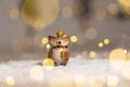 Decorative figurine toy owl with a golden crown on his head. Festive decor, warm bokeh lights Royalty Free Stock Photo