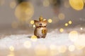 Decorative figurine toy owl with a golden crown on his head. Festive decor, warm bokeh lights Royalty Free Stock Photo