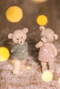 Decorative figurines of a Christmas theme. Figurines of cute teddy bears of a boy and a girl in sweaters with deers. Festive decor