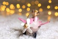 Decorative figurines of a Christmas theme. Santa s Deer in a pink airplane with a propeller. Festive decor, warm bokeh lights Royalty Free Stock Photo